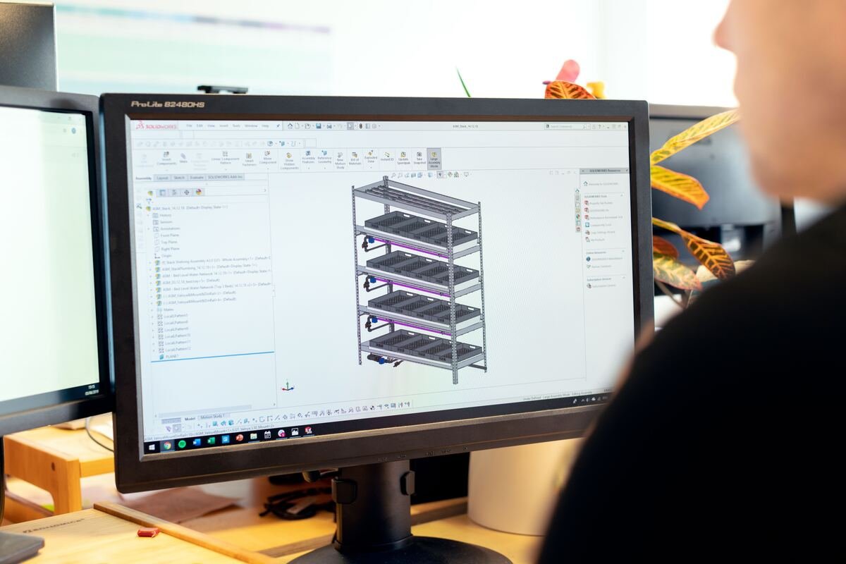 Engineer reviewing a 3D CAD model on a workstation