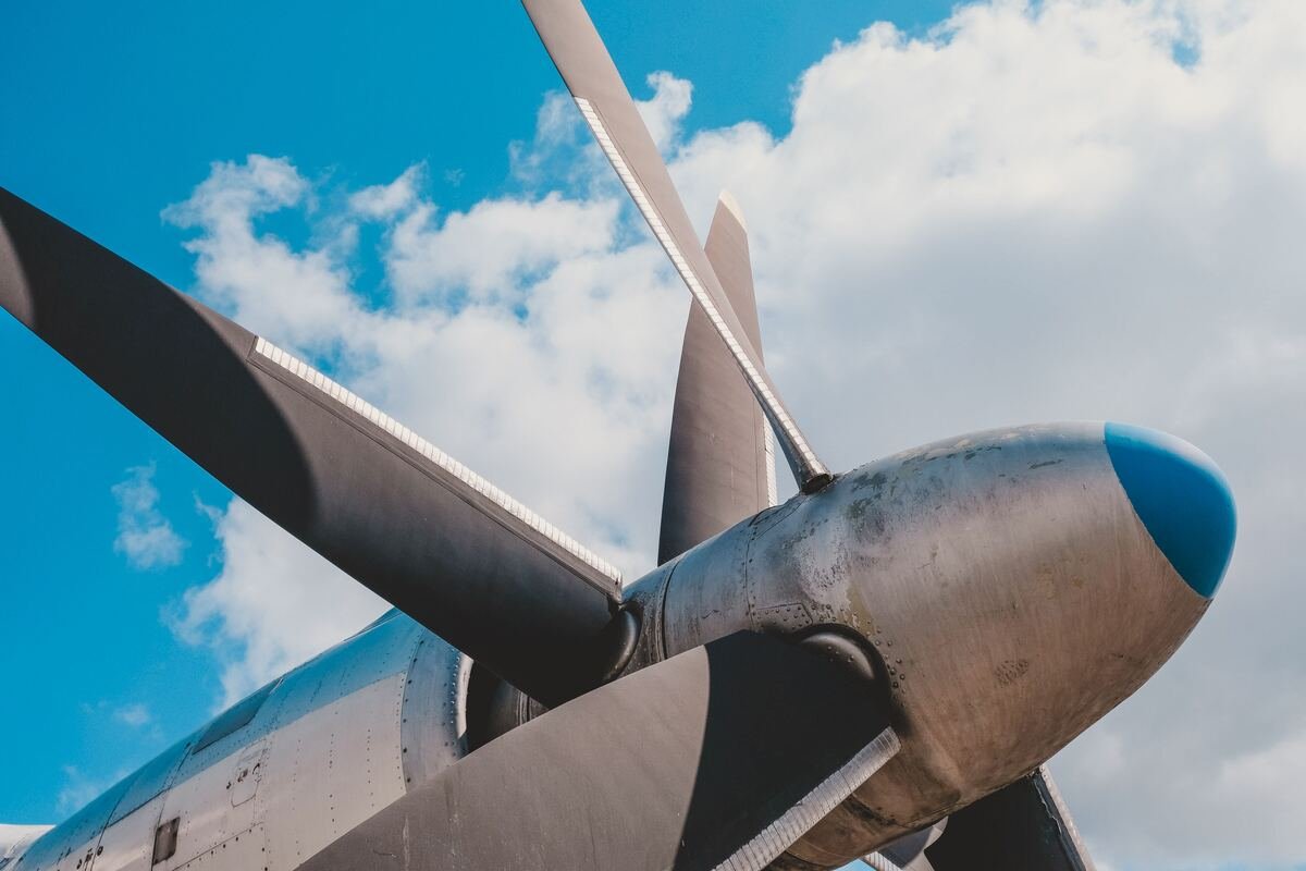 Aircraft wing and propeller against the sky